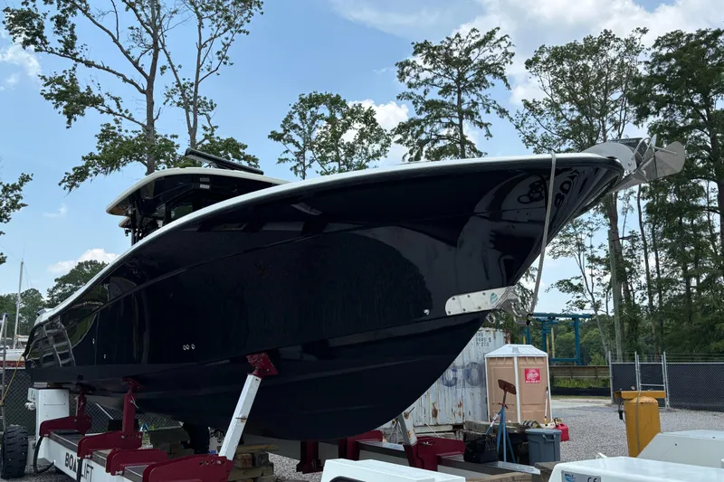  Yacht Photos Pics 2017 HCB Speciale boat on a lift, surrounded by trees and equipment.