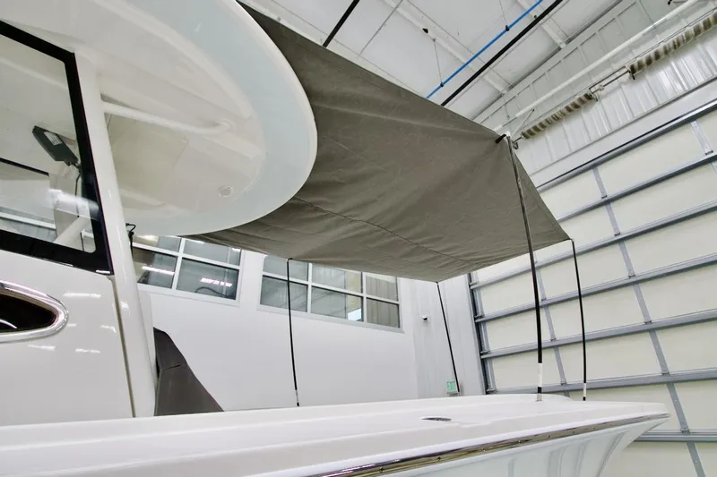 31-406 Yacht Photos Pics 2026 Regulator 31 boat with canopy in a modern indoor facility.
