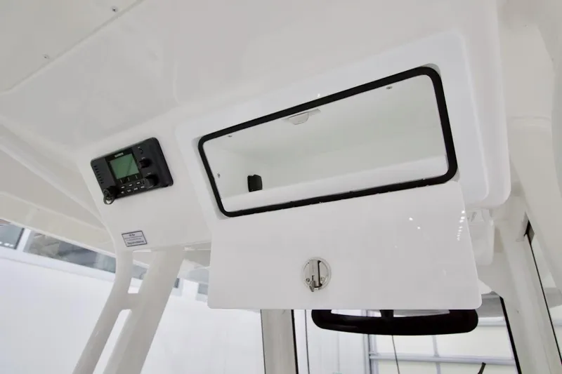 31-406 Yacht Photos Pics 2026 Regulator 31 boat console with open storage compartment and electronic display.