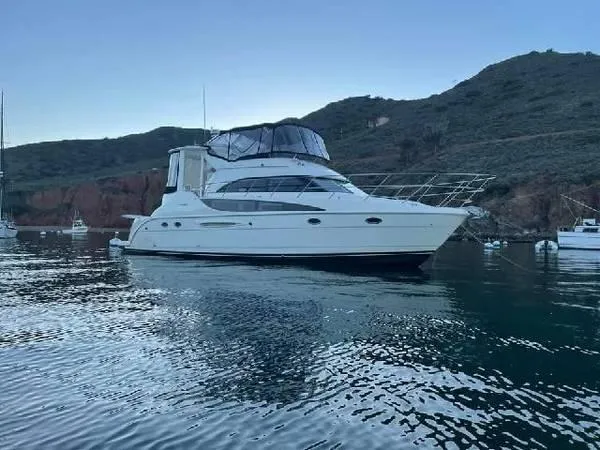 Embracing Life Yacht Photos Pics 2004 Meridian 459 Motoryacht anchored in scenic bay with hills in background.