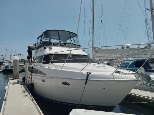 Embracing Life Yacht Photos Pics 2004 Meridian 459 Motoryacht docked at a marina under clear skies.