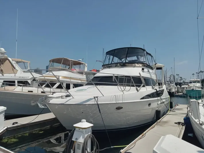 Embracing Life Yacht Photos Pics 2004 Meridian 459 Motoryacht docked at marina under clear blue sky.