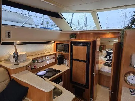 Embracing Life Yacht Photos Pics Interior of 2004 Meridian 459 Motoryacht with kitchen and cozy bedroom.