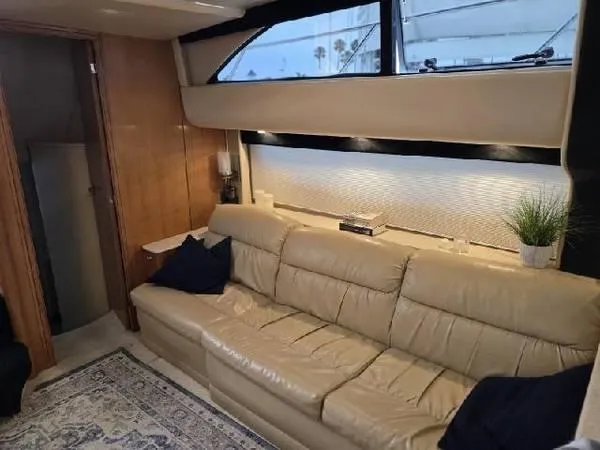 Embracing Life Yacht Photos Pics Luxurious interior of 2004 Meridian 459 Motoryacht with beige leather sofa and elegant decor.