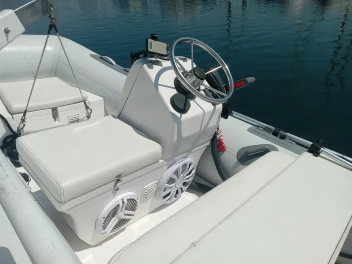 Embracing Life Yacht Photos Pics 2004 Meridian 459 Motoryacht interior with steering wheel and seating, docked on calm water.