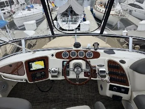 Embracing Life Yacht Photos Pics 2004 Meridian 459 Motoryacht helm with navigation equipment and marina view.