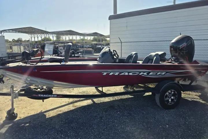 2021 Tracker Pro Team 195 TXW Tournament Edition boat, red, parked on trailer.