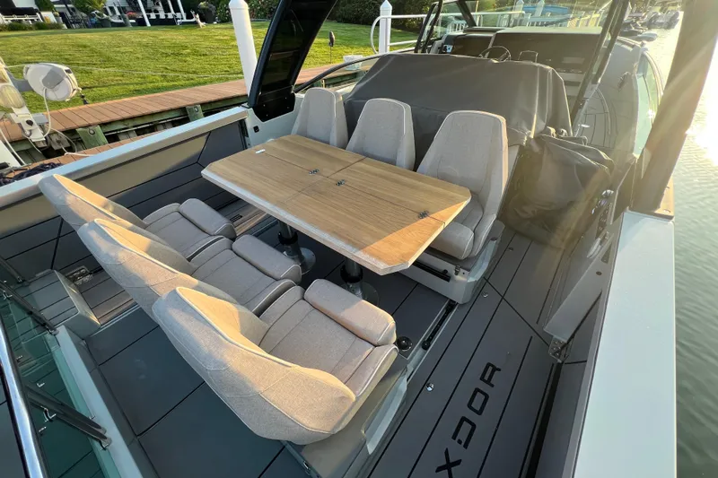  Yacht Photos Pics 2023 Saxdor 320 GTO boat interior with seating and wooden table.