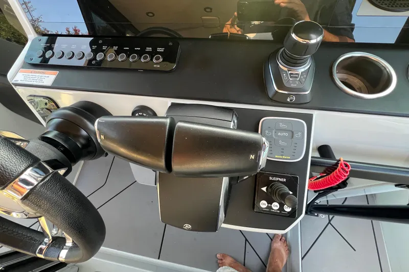  Yacht Photos Pics Control panel of 2023 Saxdor 320 GTO boat with steering wheel and throttle.