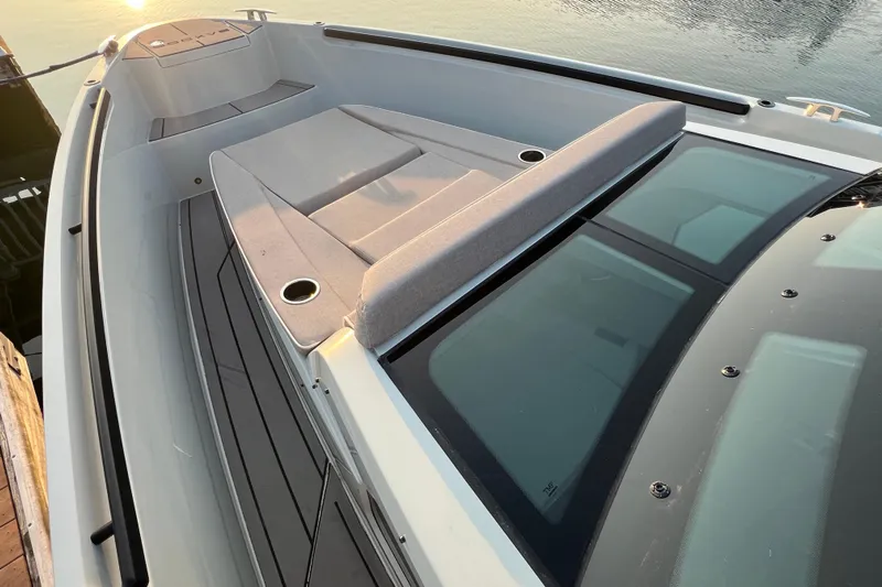  Yacht Photos Pics 2023 Saxdor 320 GTO boat deck with sunbed and sleek design at sunset.