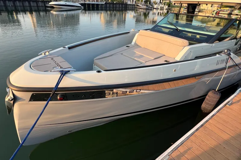  Yacht Photos Pics 2023 Saxdor 320 GTO boat docked in a marina, sleek design and modern features.