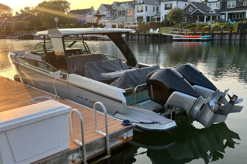  Yacht Photos Pics 2023 Saxdor 320 GTO docked by waterfront homes at sunset.