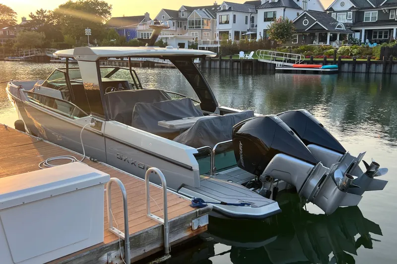  Yacht Photos Pics 2023 Saxdor 320 GTO docked by waterfront homes at sunset.