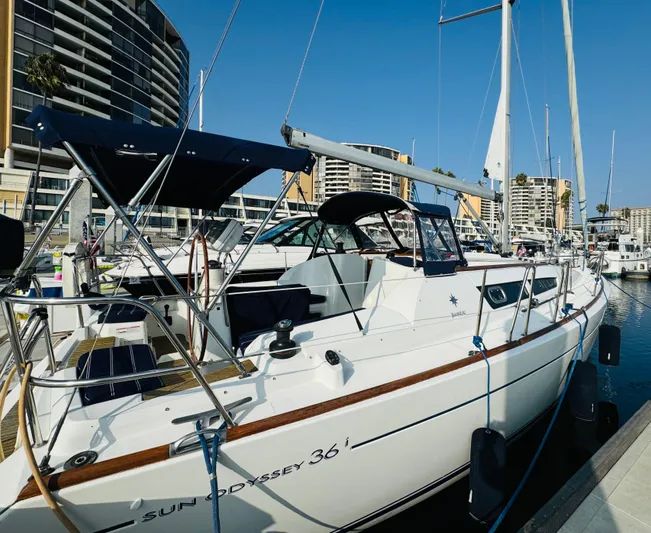 La Dauphine Yacht Photos Pics 2007 Jeanneau Sun Odyssey 36i sailboat docked in marina, clear blue sky.