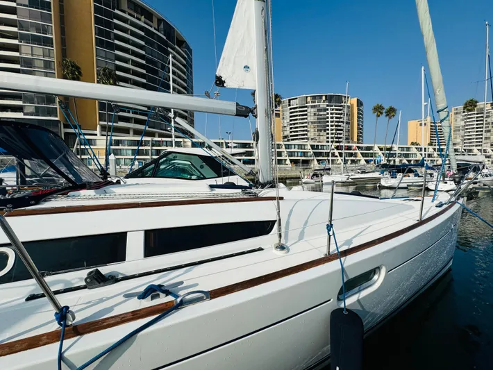 La Dauphine Yacht Photos Pics Jeanneau Sun Odyssey 36i 2007 sailboat docked in marina with modern buildings.