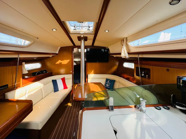 La Dauphine Yacht Photos Pics Interior of 2007 Jeanneau Sun Odyssey 36i sailboat, featuring elegant wood finish and cozy seating.
