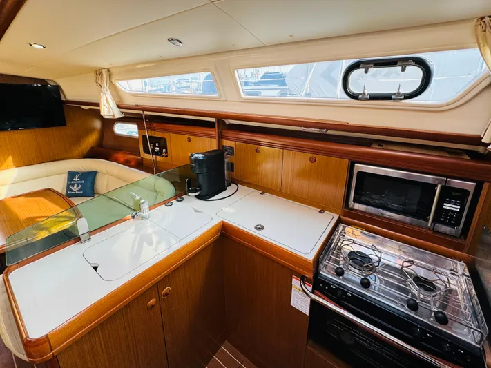 La Dauphine Yacht Photos Pics Interior of 2007 Jeanneau Sun Odyssey 36i yacht with modern kitchen and seating area.