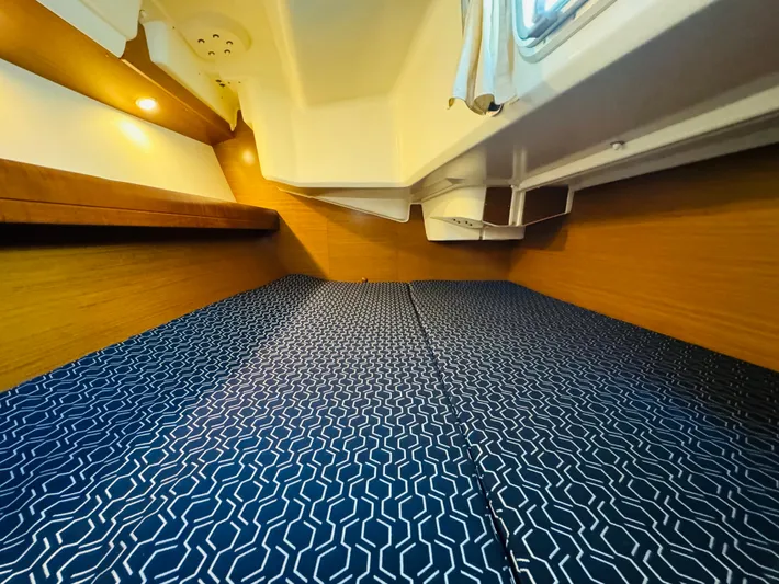 La Dauphine Yacht Photos Pics Cozy cabin interior of 2007 Jeanneau Sun Odyssey 36i sailboat with patterned bedding.