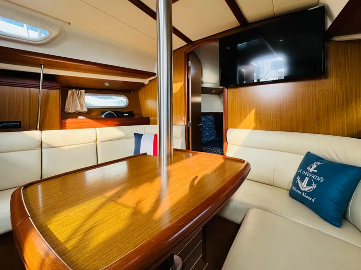 La Dauphine Yacht Photos Pics Interior of 2007 Jeanneau Sun Odyssey 36i yacht with cozy seating and wooden finishes.