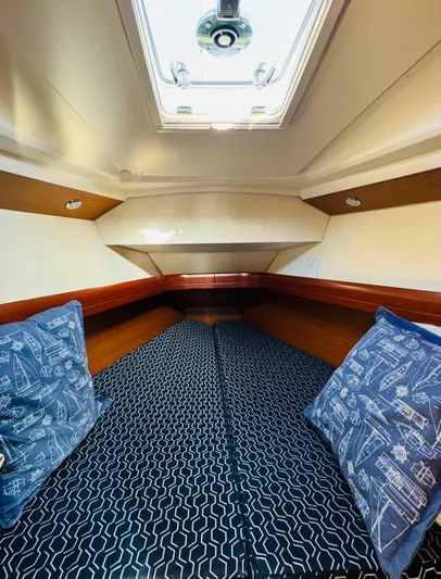 La Dauphine Yacht Photos Pics Interior cabin of 2007 Jeanneau Sun Odyssey 36i sailboat with patterned bedding.