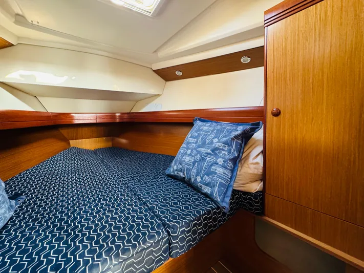 La Dauphine Yacht Photos Pics Cozy cabin interior of 2007 Jeanneau Sun Odyssey 36i sailboat with patterned bedding.