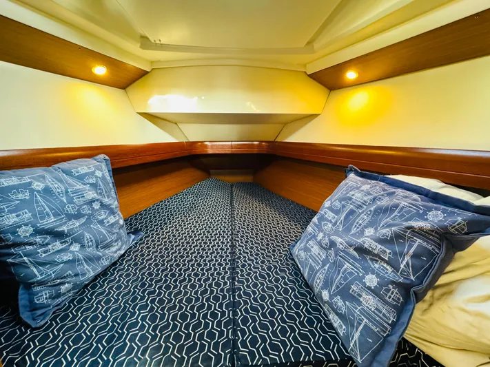 La Dauphine Yacht Photos Pics Cozy cabin interior of 2007 Jeanneau Sun Odyssey 36i sailboat with nautical-themed pillows.