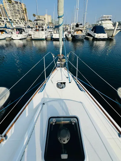 La Dauphine Yacht Photos Pics Jeanneau Sun Odyssey 36i sailboat docked in marina, 2007 model, surrounded by other boats.
