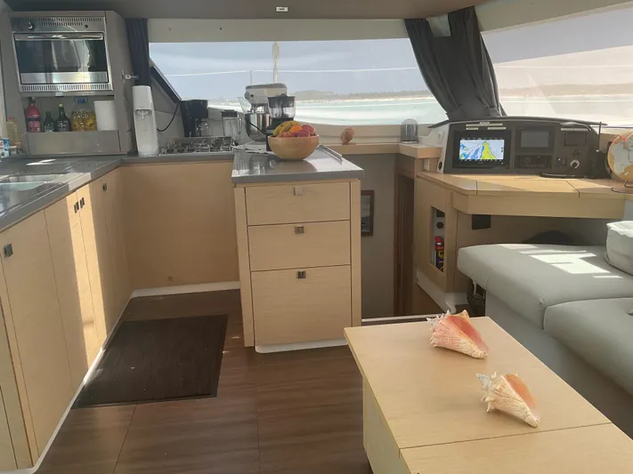 Anth'r'flo Yacht Photos Pics Interior of 2017 Fountaine Pajot Helia catamaran with modern kitchen and navigation area.
