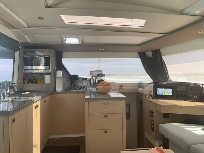 Anth'r'flo Yacht Photos Pics Modern kitchen interior of 2017 Fountaine Pajot Helia catamaran with navigation equipment.