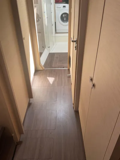 Anth'r'flo Yacht Photos Pics Interior hallway of 2017 Fountaine Pajot Helia catamaran with wood flooring and washing machine.