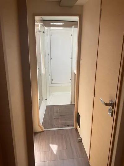 Anth'r'flo Yacht Photos Pics Interior hallway of 2017 Fountaine Pajot Helia catamaran with modern design and wooden flooring.