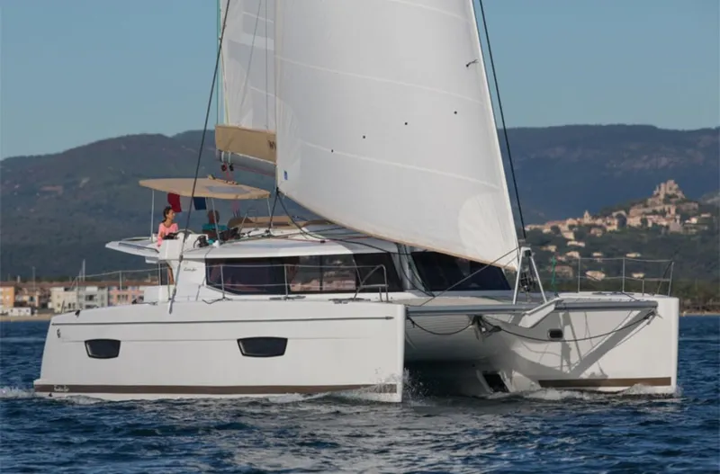 Anth'r'flo Yacht Photos Pics 2017 Fountaine Pajot Helia catamaran sailing on open water with scenic background.
