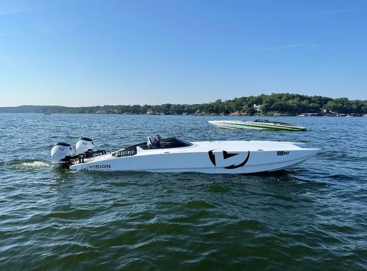  Yacht Photos Pics 2021 HellKats 32 electric boat cruising on a sunny lake with scenic background.