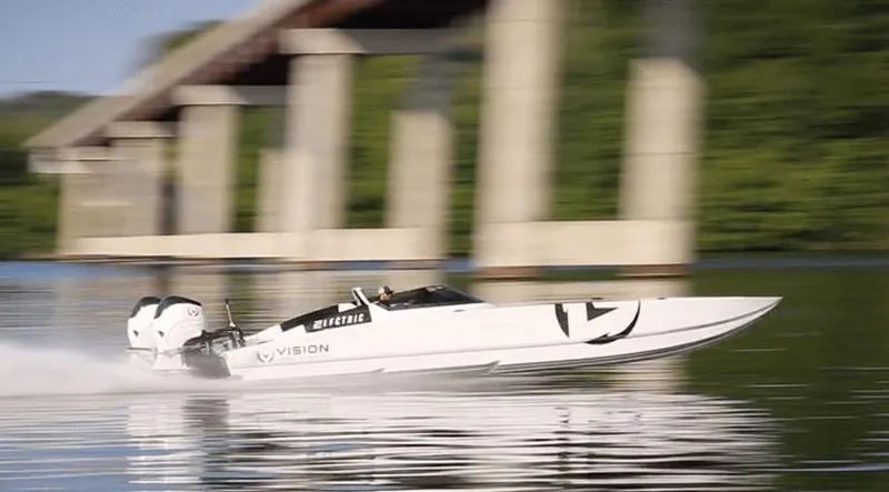  Yacht Photos Pics High-speed HellKats 32 powerboat on water, 2021 model, with bridge and greenery in background.