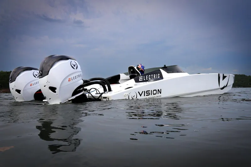  Yacht Photos Pics Electric HellKats 32 boat on water, featuring dual outboard motors, 2021 model.