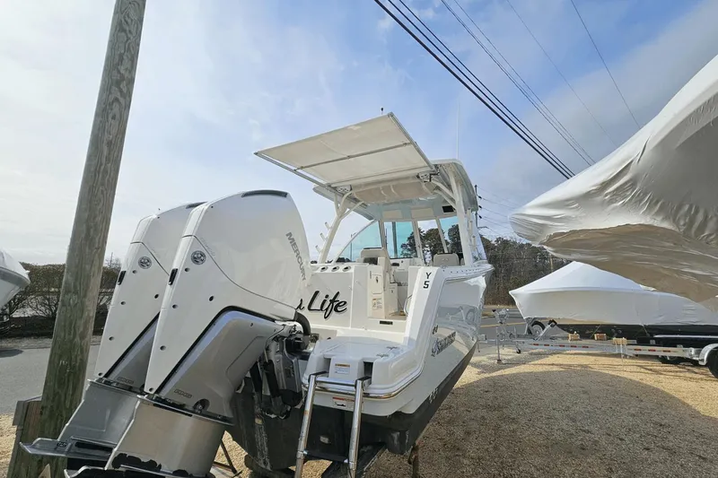  Yacht Photos Pics 2023 Sailfish 316 DC boat with dual Mercury outboard engines, docked outdoors.