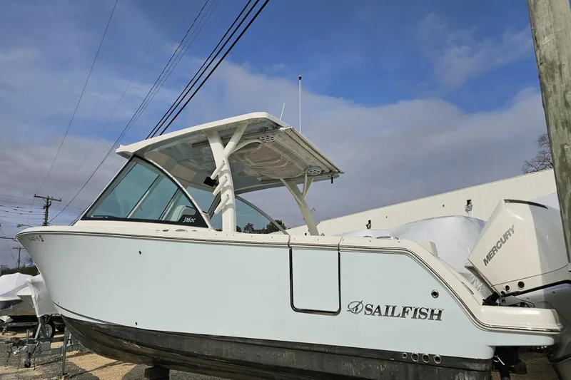  Yacht Photos Pics 2023 Sailfish 316 DC boat with Mercury engine, docked under a clear blue sky.