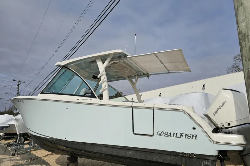  Yacht Photos Pics 2023 Sailfish 316 DC boat with Mercury engine, docked outdoors.