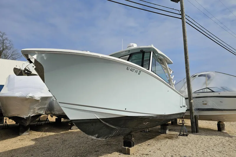  Yacht Photos Pics 2023 Sailfish 316 DC boat on display, parked on a gravel lot.