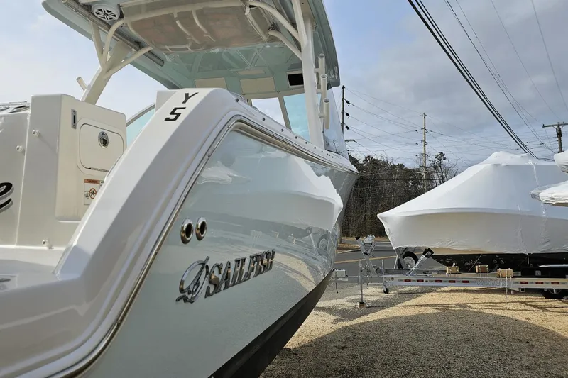  Yacht Photos Pics 2023 Sailfish 316 DC boat on trailer, side view, outdoors.
