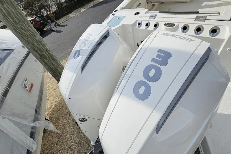  Yacht Photos Pics 2023 Sailfish 316 DC boat with dual Mercury 300 engines, docked outdoors.