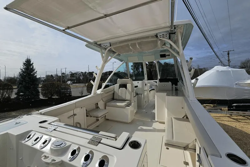  Yacht Photos Pics 2023 Sailfish 316 DC boat interior with seating and control panel, docked outdoors.