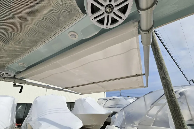  Yacht Photos Pics 2023 Sailfish 316 DC boat with canopy and speaker system, docked outdoors.