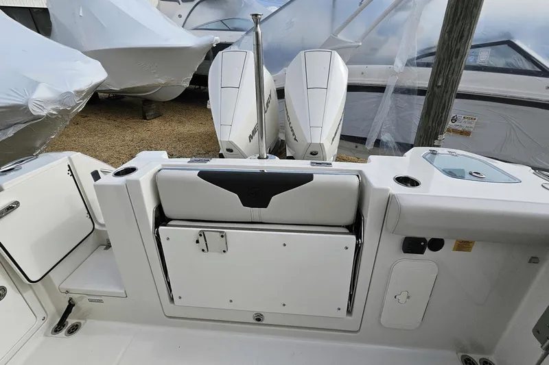  Yacht Photos Pics 2023 Sailfish 316 DC boat interior with dual Mercury engines and seating area.