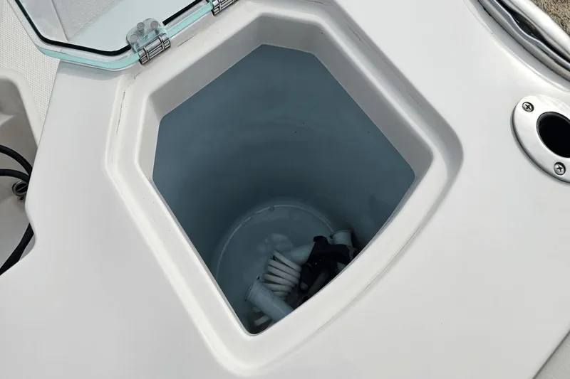  Yacht Photos Pics Open storage compartment on 2023 Sailfish 316 DC boat, showing interior details.