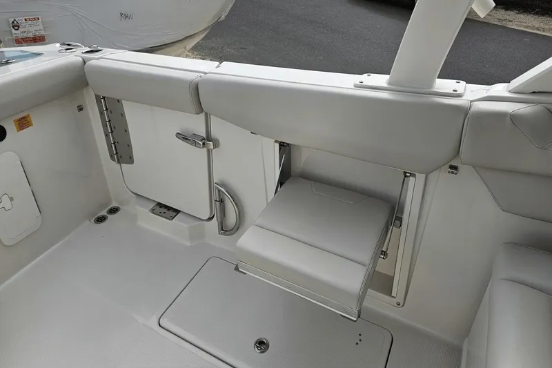  Yacht Photos Pics 2023 Sailfish 316 DC boat interior with foldable seat and storage compartment.