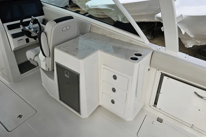  Yacht Photos Pics 2023 Sailfish 316 DC boat interior with helm, seating, and storage compartments.
