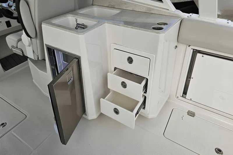  Yacht Photos Pics 2023 Sailfish 316 DC boat interior with sink, drawers, and mini fridge.