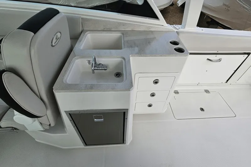  Yacht Photos Pics 2023 Sailfish 316 DC boat interior with sink, storage, and seating.