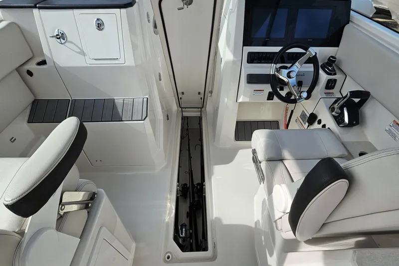  Yacht Photos Pics 2023 Sailfish 316 DC boat interior with steering wheel and seating area.